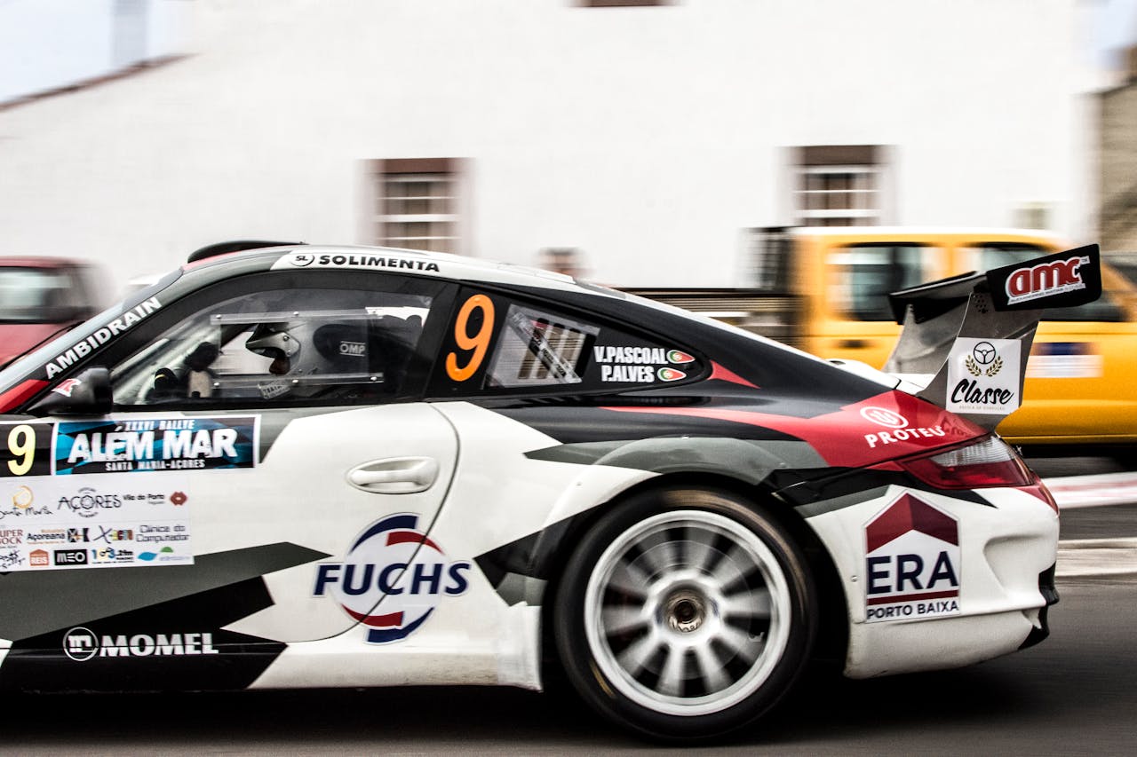 About Dynamic shot of a sports car speeding by a city street race track.